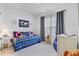 This bedroom features a bed with navy striped bedding, decor, and bright window at 523 Fern Tree Dr, Summerville, SC 29486