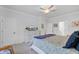Well-lit bedroom with a ceiling fan, accent lamps, and a large bed with many pillows and TV on dresser at 523 Fern Tree Dr, Summerville, SC 29486