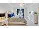 Well-lit bedroom with a ceiling fan, accent lamps, and a large bed with many pillows at 523 Fern Tree Dr, Summerville, SC 29486
