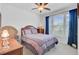 Cozy bedroom with a ceiling fan, bright window, and comfortable queen-size bed at 523 Fern Tree Dr, Summerville, SC 29486