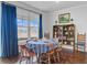 Elegant dining area with a round table, wooden chairs, and ample natural light from the large window at 523 Fern Tree Dr, Summerville, SC 29486