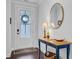 Elegant foyer showcasing hardwood floors, a stylish console table, decorative mirror, and natural light at 523 Fern Tree Dr, Summerville, SC 29486
