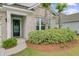 Inviting front entrance showcasing beautiful landscaping, palm trees, and a charming front door at 523 Fern Tree Dr, Summerville, SC 29486