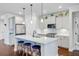 Bright modern kitchen with stainless steel appliances, white cabinets, and kitchen island with barstool seating at 523 Fern Tree Dr, Summerville, SC 29486