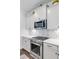 Close up view of the stainless steel oven and stove with white cabinets and marble backsplash at 523 Fern Tree Dr, Summerville, SC 29486