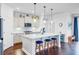 Bright modern kitchen with stainless steel appliances, white cabinets, and kitchen island with barstool seating at 523 Fern Tree Dr, Summerville, SC 29486