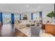 Spacious living room with hardwood flooring, a large sectional sofa, and plenty of natural light at 523 Fern Tree Dr, Summerville, SC 29486