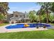 Inviting backyard with a sparkling pool, lush lawn, and a two-story home at 5401 Diston Court, North Charleston, SC 29420