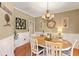 Dining room with an oval table, white chairs, wainscoting, and a decorative chandelier at 5401 Diston Court, North Charleston, SC 29420