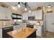 Well-lit kitchen with a center island, white cabinetry, and modern appliances at 5401 Diston Court, North Charleston, SC 29420