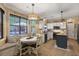 Eat in kitchen with white cabinets, island, and dining area with large window and built in bench seating at 5401 Diston Court, North Charleston, SC 29420