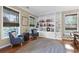 Cozy living room features built-in shelving, comfortable seating, and natural light from two windows at 5401 Diston Court, North Charleston, SC 29420