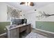 This charming home office features wood floors, a rustic desk, and stylish wall décor at 5401 Diston Court, North Charleston, SC 29420