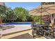 Relaxing pool area with lounge chairs, an outdoor dining set, and a lush green backyard at 5401 Diston Court, North Charleston, SC 29420