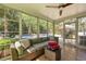 Bright sunroom with comfortable seating offering views of the outdoor pool and backyard at 5401 Diston Court, North Charleston, SC 29420