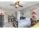 Well-lit bedroom with ceiling fan, desk, dresser, and closet at 565 Travelers Blvd, Summerville, SC 29485