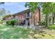 Exterior view of townhome with a fenced backyard, brick facade, and upper-level balcony at 565 Travelers Blvd, Summerville, SC 29485