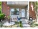 Inviting front porch with red brick and landscaped garden, complete with an American flag at 565 Travelers Blvd, Summerville, SC 29485