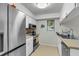 Bright kitchen with stainless steel appliances, white cabinets and tiled floor at 565 Travelers Blvd, Summerville, SC 29485