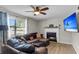 Inviting living room with a cozy fireplace, modern ceiling fan and lots of natural light at 565 Travelers Blvd, Summerville, SC 29485