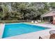 Community pool featuring refreshing blue water, poolside seating, and mature landscaping for a relaxing atmosphere at 565 Travelers Blvd, Summerville, SC 29485