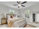 Bright bedroom features neutral decor, a ceiling fan, and a large window with natural light at 5817 Canterbury Dr, Hanahan, SC 29410