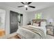 Bedroom boasts a ceiling fan, view into the attached bath, and neutral color palette at 5817 Canterbury Dr, Hanahan, SC 29410
