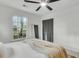 Airy bedroom showcases modern ceiling fan, a large window, and a neutral color palette at 5817 Canterbury Dr, Hanahan, SC 29410