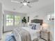 Light-filled bedroom features large windows, modern ceiling fan, and stylish decor at 5817 Canterbury Dr, Hanahan, SC 29410