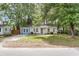 Charming single-story home with a colorful facade and a well-maintained front lawn at 5817 Canterbury Dr, Hanahan, SC 29410
