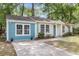 Charming single-story home with a delightful blue accent and a well-manicured front yard at 5817 Canterbury Dr, Hanahan, SC 29410