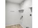 A clean and functional laundry room featuring streamlined white walls and essential utility connections at 5817 Canterbury Dr, Hanahan, SC 29410