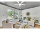 Bright living room featuring hardwood floors, white furnishings, and two large windows at 5817 Canterbury Dr, Hanahan, SC 29410