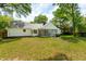 Spacious backyard featuring a well-maintained lawn, mature trees, and an inviting screened porch at 667 Shortwood St, Charleston, SC 29412