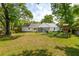 Expansive backyard with white siding, a screened porch, and mature trees is perfect for recreation at 667 Shortwood St, Charleston, SC 29412