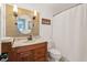 Bathroom featuring tiled wall accents, rounded mirror, and vanity sink at 667 Shortwood St, Charleston, SC 29412
