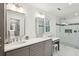 Bright bathroom featuring double vanity, marble floors, and walk-in shower at 667 Shortwood St, Charleston, SC 29412
