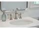 Close up of updated bathroom sink with designer faucet and white countertop at 667 Shortwood St, Charleston, SC 29412