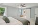 Bedroom featuring sliding barn door to bath, neutral walls, carpet, and ceiling fan at 667 Shortwood St, Charleston, SC 29412