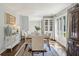 Bright dining room with hardwood floors, area rug, and large window views at 667 Shortwood St, Charleston, SC 29412