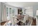 Sunlit dining room with hardwood floors, area rug, and large bay window at 667 Shortwood St, Charleston, SC 29412