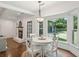 Bright dining area featuring a white table, hardwood floors, and a view of the backyard at 667 Shortwood St, Charleston, SC 29412