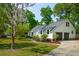 Side angle showcasing a home with an attached garage, surrounded by a well maintained lawn at 667 Shortwood St, Charleston, SC 29412