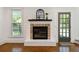 Close up of a modern fireplace with brick surround and a dark wood mantel at 667 Shortwood St, Charleston, SC 29412