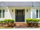 Stylish front door with sidelights, brick steps, and neatly trimmed shrubs for added charm at 667 Shortwood St, Charleston, SC 29412