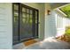 Elegant front door with a 'welcome' mat, enhanced by natural lighting and a clean design at 667 Shortwood St, Charleston, SC 29412