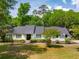 Charming one-story home with a well-manicured lawn and a classic black front door at 667 Shortwood St, Charleston, SC 29412
