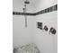 Modern shower featuring mosaic tile accents, rainfall shower head and designer hardware at 667 Shortwood St, Charleston, SC 29412