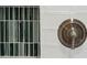 Close up of modern shower with mosaic tile accents, built in niche, and designer hardware at 667 Shortwood St, Charleston, SC 29412