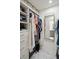 Bright walk-in closet featuring custom shelving, mirrored accent, and marble floors at 667 Shortwood St, Charleston, SC 29412